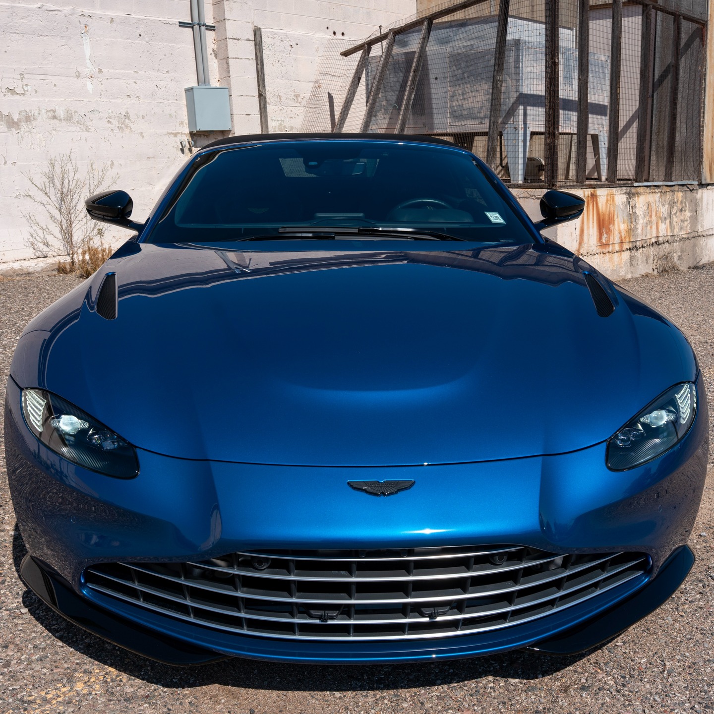 Blue Aston Martin front view
