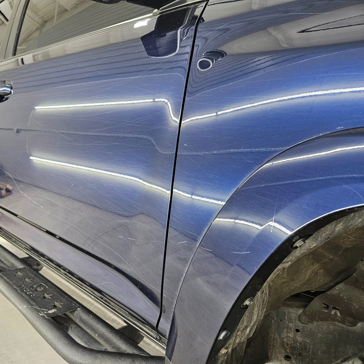 Reflective dark blue Toyota 4Runner side panel