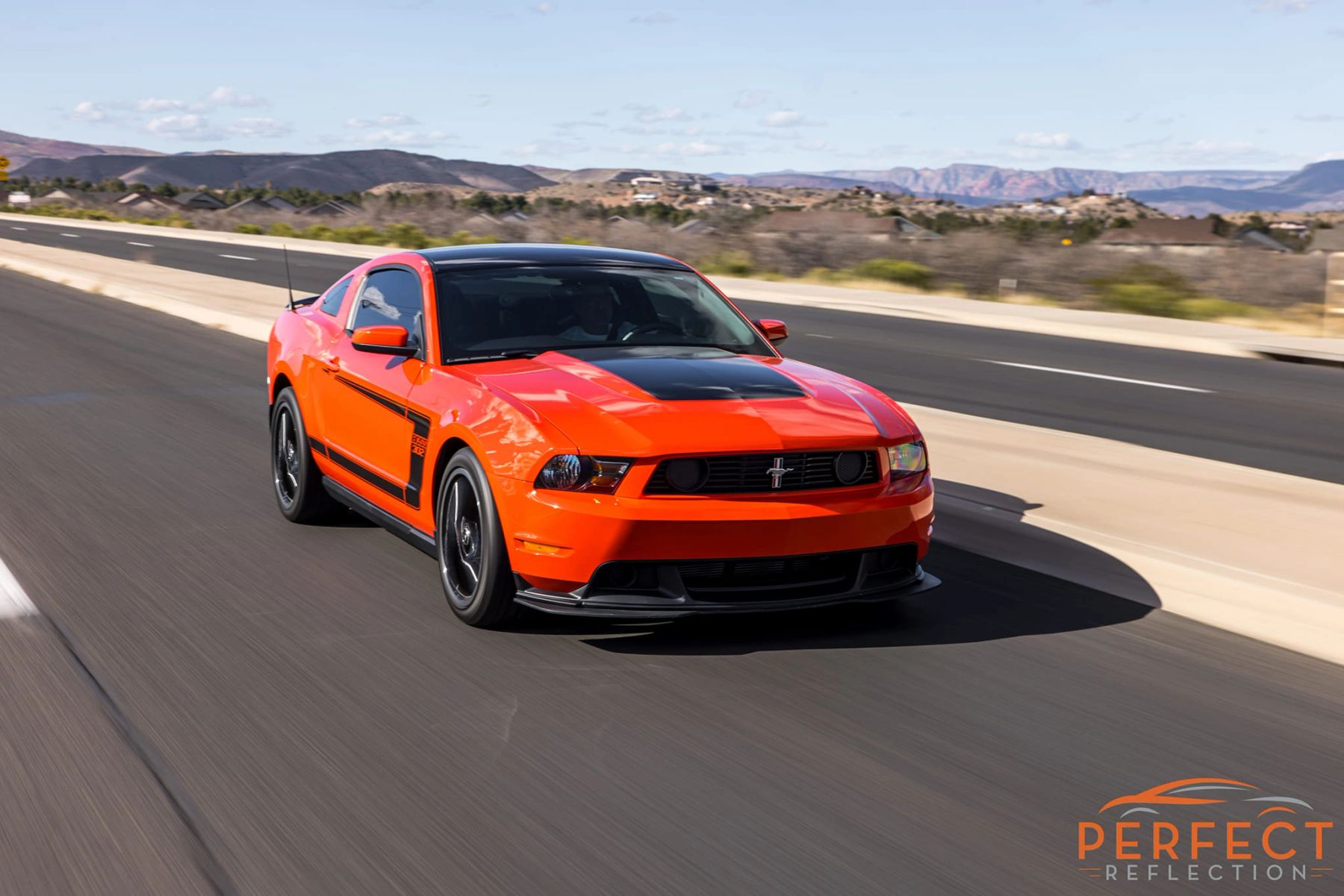 Orange Ford Mustang on the road